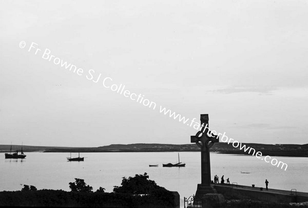 SCENE OVER BAY WITH CROSS IN FOREGROUND